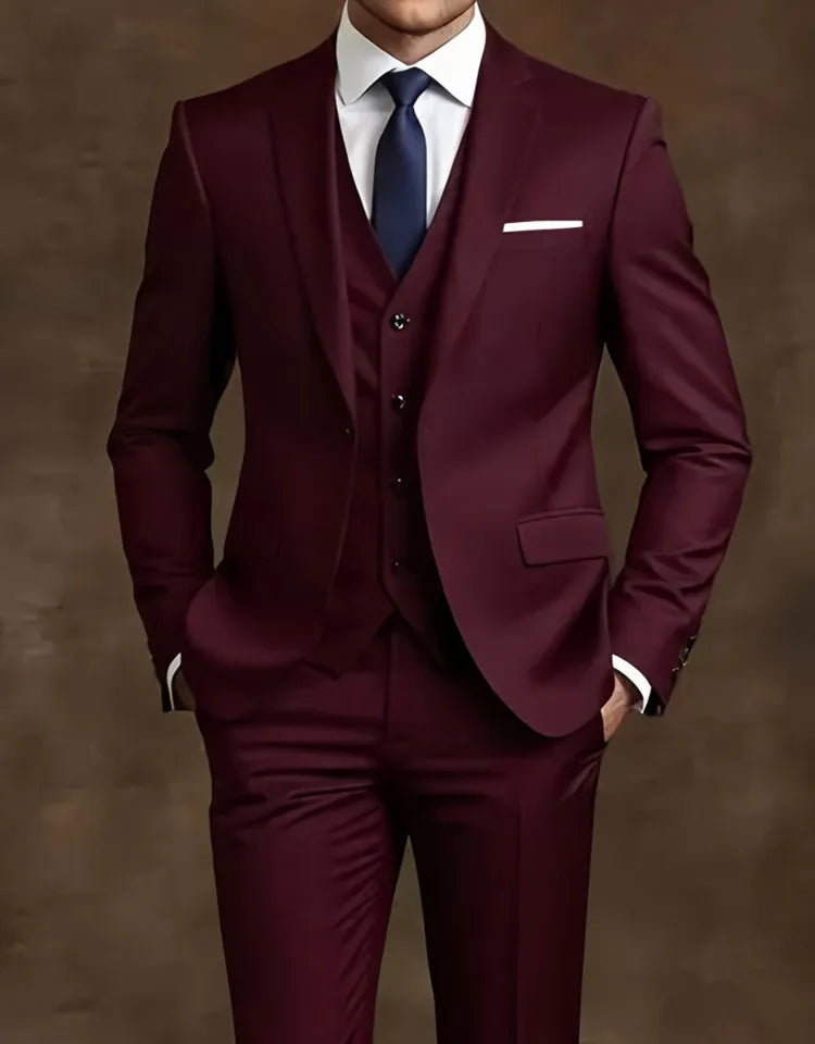 Maroon suit with a white shirt and blue tie  