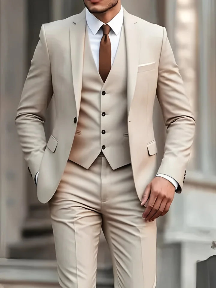 beige suit with a white shirt and brown tie.